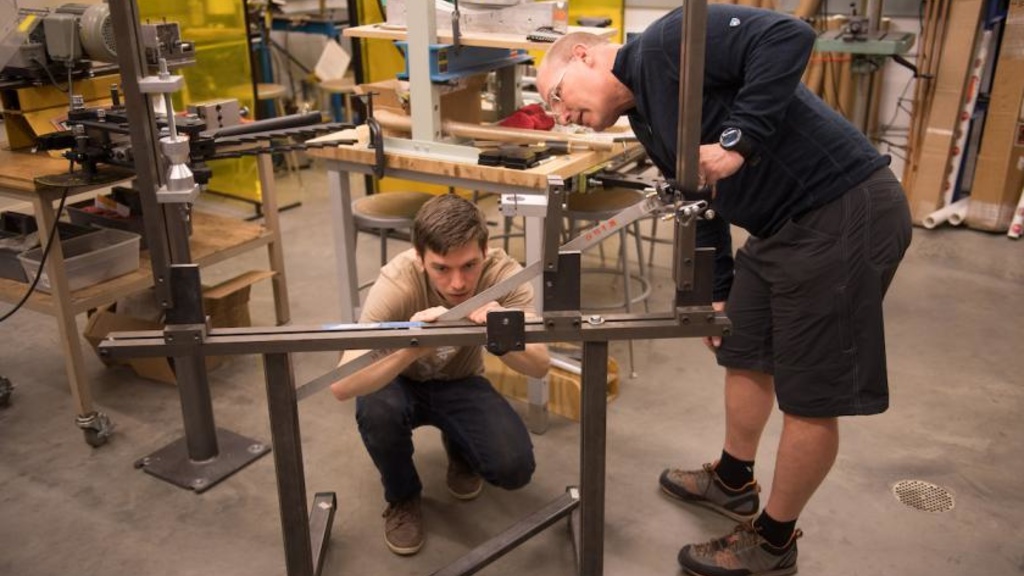 Steve McGuire helping a student in his bike building course