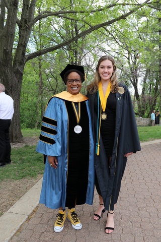 Nembhard poses with a student on graduation day