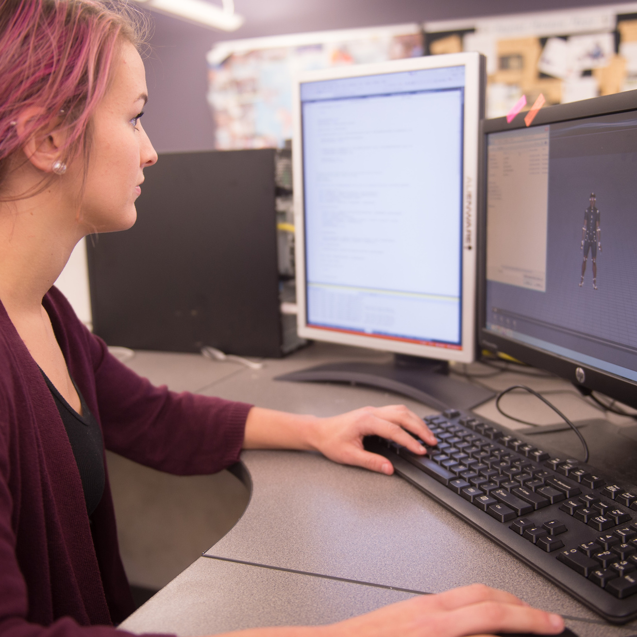 Female student using desktop computer and there is a virtual man on the screen