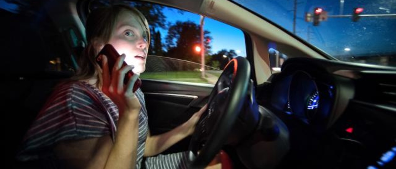 Woman driving while talking on the phone