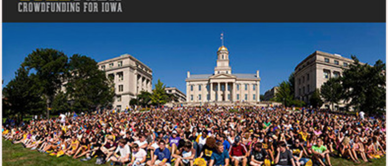 A large number of students sitting on the Pentacrest lawn in Iowa City