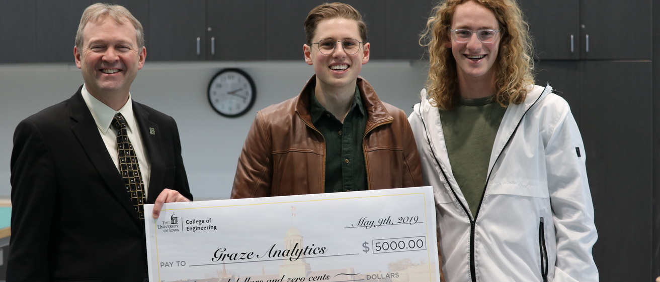 Graze Analytics holding a large $5,000 check