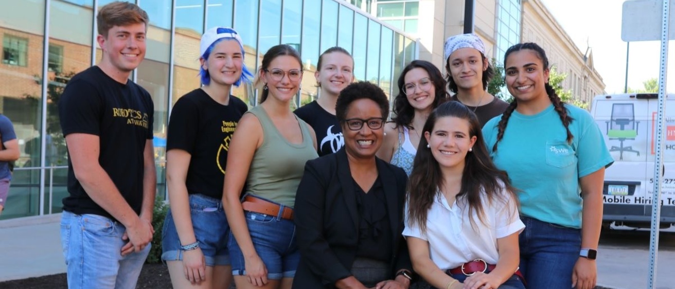 Harriet Nembhard poses with students outside the Seamans Center