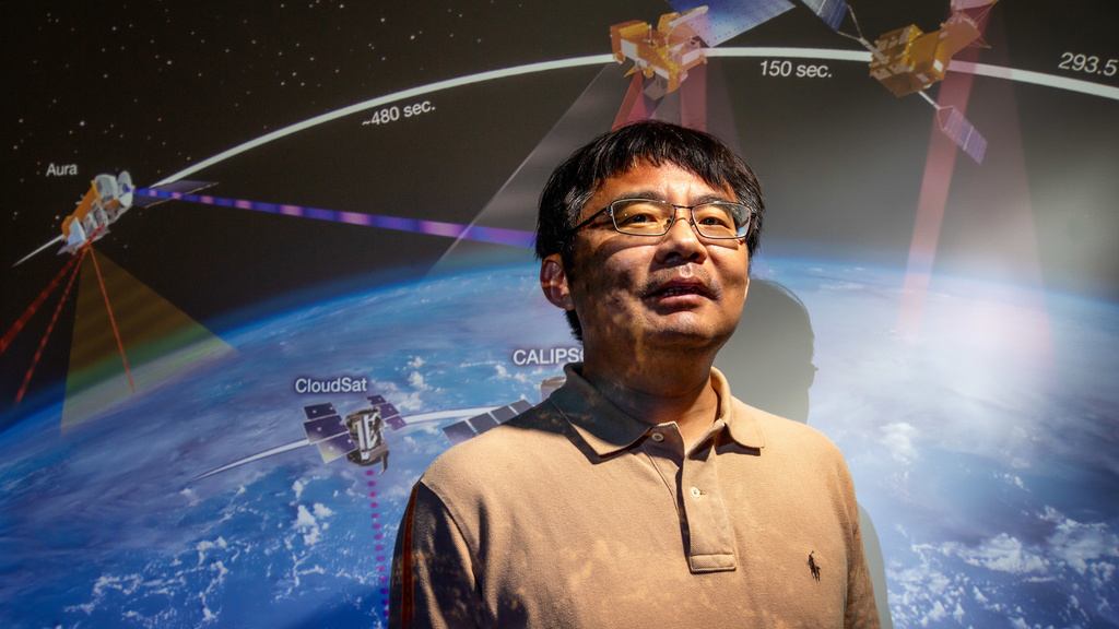 Jun wang standing in front of space background